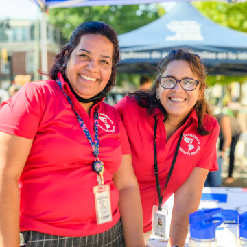 Two volunteers smiling