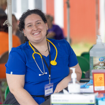 Person smiling and wearing a stethoscope