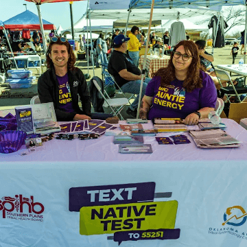 Smiling people offering tests in tent