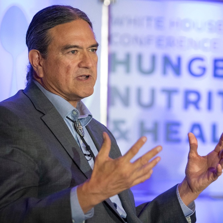 A person speaking at a hunger and nutrition conference