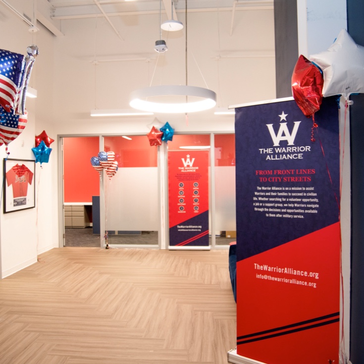 The Warrior Alliance lobby, decorated with signage and American flag-themed balloons