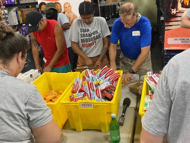 Volunteers and staff work at the Community Resource Center (CRC) pack Hygiene Kits 