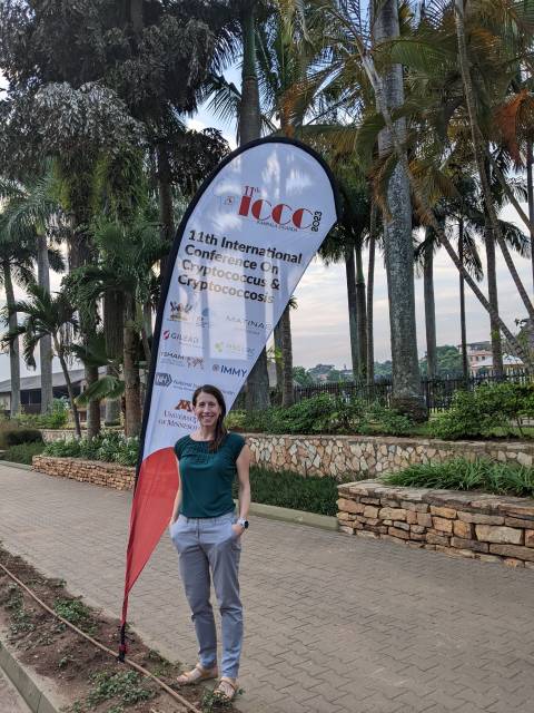 Rebecca Cook standing in front of a sign for the ICC