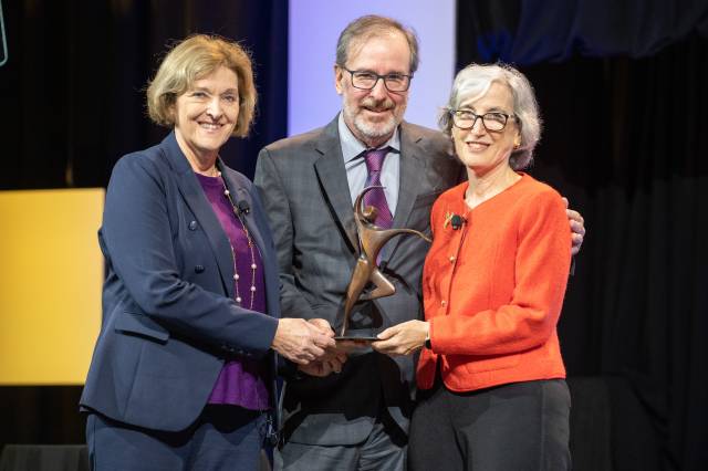 Gregory Fries and Dr. Judy Monroe present the 2023 Fries Prize to Dr Anne Schuchat during the APHA opening day event in Atlanta, Georgia.