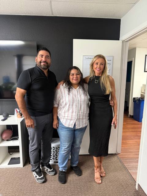 Three people smiling together