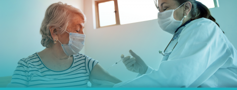 elderly woman receiving a vaccine