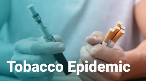 holding e-cigarette and cigarettes