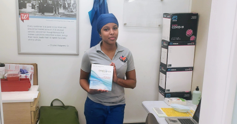 Community Care Resources Inc  woman holding covid kit