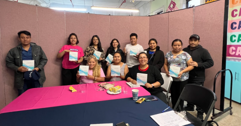 A group of people pose with HIV self-testing kits