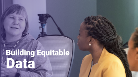 woman talking to another woman at a conference table