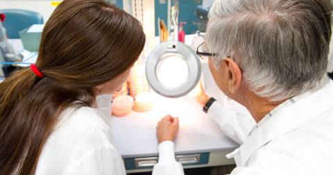 Two people looking at a sample together