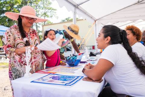 Volunteers with the Houston-based Civic Heart Community Services speak to community members at a health expo